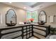 Bathroom featuring double sinks with designer faucets, large vanity and a skylight at 3493 Wood Acres Blvd, Duluth, GA 30096