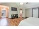 A spacious bedroom with herringbone wood floors is equipped with a TV, storage, and bathroom access at 3493 Wood Acres Blvd, Duluth, GA 30096