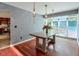 Elegant dining area with a table, statement lighting, and large windows for natural light and views at 3493 Wood Acres Blvd, Duluth, GA 30096