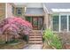 A welcoming front entrance with stone steps, a decorative door, and colorful foliage adding charm at 3493 Wood Acres Blvd, Duluth, GA 30096