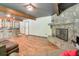 Open-concept living room with fireplace, bar area, hardwood floors, and comfortable seating at 3493 Wood Acres Blvd, Duluth, GA 30096