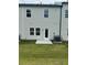 Backyard featuring a small patio area and a grassy lawn at 5522 Cosimo Rd, Fairburn, GA 30213