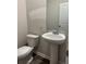 Powder room featuring pedestal sink and toilet at 5522 Cosimo Rd, Fairburn, GA 30213