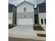 Charming townhome featuring a two-car garage and neutral-toned exterior at 5522 Cosimo Rd, Fairburn, GA 30213