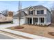 Charming two-story home with a manicured lawn and a two-car garage, perfect for Gathering living at 7166 Linden Dr, South Fulton, GA 30349