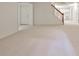 Finished basement features stairs, a door, and an open view of an additional room at 389 Mill Creek Ne Bnd, Atlanta, GA 30307