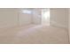 Spacious carpeted basement with light-colored walls and a small window, perfect for storage or finishing at 389 Mill Creek Ne Bnd, Atlanta, GA 30307