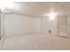 Finished basement with carpet, light-colored walls, and a closed door at 389 Mill Creek Ne Bnd, Atlanta, GA 30307