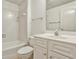 Bright bathroom featuring a tiled shower-tub combo, toilet, and vanity with storage at 389 Mill Creek Ne Bnd, Atlanta, GA 30307