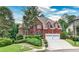 Charming red brick two-story home with well-maintained landscaping and a two-car garage at 389 Mill Creek Ne Bnd, Atlanta, GA 30307
