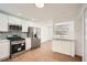 Modern kitchen with stainless steel appliances, white cabinets, and a snack bar at 4201 Regal Ridge Rd, Austell, GA 30106