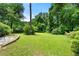 Beautiful backyard with lush greenery and mature trees at 6033 Morrow Cv, Morrow, GA 30260
