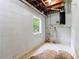 Basement with white-painted walls and a window view of the yard at 6033 Morrow Cv, Morrow, GA 30260