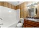 Bathroom with dark wood vanity and shower/tub combo at 6033 Morrow Cv, Morrow, GA 30260