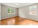 Bedroom with hardwood floors and views from two windows at 6033 Morrow Cv, Morrow, GA 30260