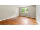 Bedroom featuring hardwood floors, a window with natural light, and neutral paint at 6033 Morrow Cv, Morrow, GA 30260