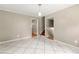 Living room featuring tile flooring, neutral paint, and access to the staircase at 6033 Morrow Cv, Morrow, GA 30260