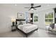 Bright bedroom featuring a ceiling fan, comfortable bed, and views of lush greenery at 6106 Marigold Way, Atlanta, GA 30349