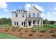 Stunning two-story brick home with covered porch, manicured lawn, and beautiful landscaping at 6106 Marigold Way, Atlanta, GA 30349