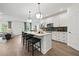 Modern eat-in kitchen with white cabinets, quartz countertops, stainless appliances and pendant lighting at 6106 Marigold Way, Atlanta, GA 30349