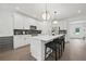 Bright kitchen features a central island with barstool seating, white cabinetry, and modern lighting at 6106 Marigold Way, Atlanta, GA 30349