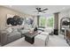 Comfortable living room with sectional seating, natural light, and modern ceiling fan at 6106 Marigold Way, Atlanta, GA 30349