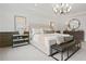 Elegant main bedroom featuring a plush bed, natural light, and modern chandelier at 6106 Marigold Way, Atlanta, GA 30349