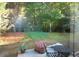 Backyard view featuring a lush lawn, a patio with outdoor furniture and beautiful landscaping at 70 Darbys Crossing Ct, Hiram, GA 30141