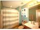 Inviting bathroom with neutral decor, a vanity with storage, and a shower with striped curtain at 70 Darbys Crossing Ct, Hiram, GA 30141