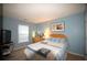 Relaxing bedroom with light-blue walls, natural light, carpeted floors, and a TV for entertainment at 70 Darbys Crossing Ct, Hiram, GA 30141
