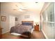 Comfortable bedroom features bright windows, a ceiling fan, and carpeted floors, creating a cozy retreat at 70 Darbys Crossing Ct, Hiram, GA 30141
