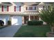 Well-maintained townhome with an attached garage, covered porch, and nicely landscaped yard at 70 Darbys Crossing Ct, Hiram, GA 30141