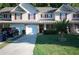 Inviting townhome featuring an attached garage, covered front porch, and lush green lawn at 70 Darbys Crossing Ct, Hiram, GA 30141