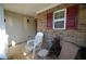 Relaxing front porch with comfortable chairs, brick details, and a peaceful outdoor space at 70 Darbys Crossing Ct, Hiram, GA 30141