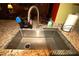 Modern kitchen sink with stainless steel fixtures and granite countertops at 70 Darbys Crossing Ct, Hiram, GA 30141