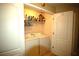 Convenient laundry room featuring washer, dryer and shelving for storage at 70 Darbys Crossing Ct, Hiram, GA 30141