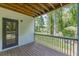 Cozy back porch with wooden decking and railings overlooking a lush, green yard and trees at 1410 Eastland Rd Se Rd, Atlanta, GA 30316