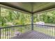 Cozy back porch with wood floors and a beautiful view of the trees and backyard at 1410 Eastland Rd Se Rd, Atlanta, GA 30316