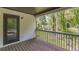 A covered balcony with grey railings has a glass door that leads to the interior of the home at 1410 Eastland Rd Se Rd, Atlanta, GA 30316