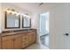 Bathroom features a granite countertop, light-wood cabinetry, an over-sized mirror, and access to the main bedroom at 1410 Eastland Rd Se Rd, Atlanta, GA 30316