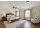 Cozy bedroom featuring a tray ceiling, ceiling fan, and plush bedding for ultimate comfort at 1410 Eastland Rd Se Rd, Atlanta, GA 30316