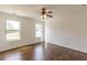 Spacious bedroom with hardwood floors, ceiling fan, and natural light from the two windows at 1410 Eastland Rd Se Rd, Atlanta, GA 30316