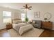 Stylishly decorated bedroom featuring neutral decor, hardwood floors, and large windows at 1410 Eastland Rd Se Rd, Atlanta, GA 30316