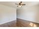 Well-lit bedroom showcases hardwood floors, neutral walls, white trim, a ceiling fan, and multiple doorways at 1410 Eastland Rd Se Rd, Atlanta, GA 30316