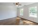 Bright bedroom with two large windows, wood floors, white trim and walls, and a modern ceiling fan at 1410 Eastland Rd Se Rd, Atlanta, GA 30316