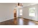 Bright bedroom with hardwood floors, white walls, a ceiling fan, and a view of the en-suite bathroom at 1410 Eastland Rd Se Rd, Atlanta, GA 30316