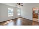 Sun-drenched bedroom features beautiful wood floors, white walls, modern ceiling fan, and access to the attached bathroom at 1410 Eastland Rd Se Rd, Atlanta, GA 30316