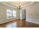 Dining room with hardwood floors, decorative lighting, chair rail molding, wainscoting and a view of the backyard at 1410 Eastland Rd Se Rd, Atlanta, GA 30316