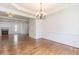 Bright dining room features hardwood floors, modern chandelier, and an open design to the living room at 1410 Eastland Rd Se Rd, Atlanta, GA 30316