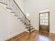 Inviting entryway with hardwood floors, stairs with decorative iron railing and a stylish wooden front door with glass panels at 1410 Eastland Rd Se Rd, Atlanta, GA 30316